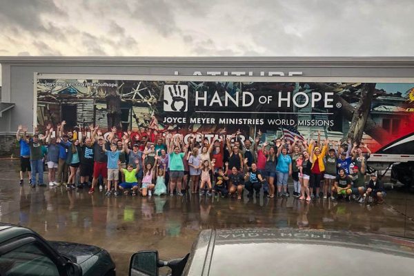 Members of Latitude Church in New Bern, NC stand in front of the GPC/Hand of Hope tractor-trailer that delivered a truckload of Blessing Buckets, water and relief supplies following Hurricane Florence in September 2018.