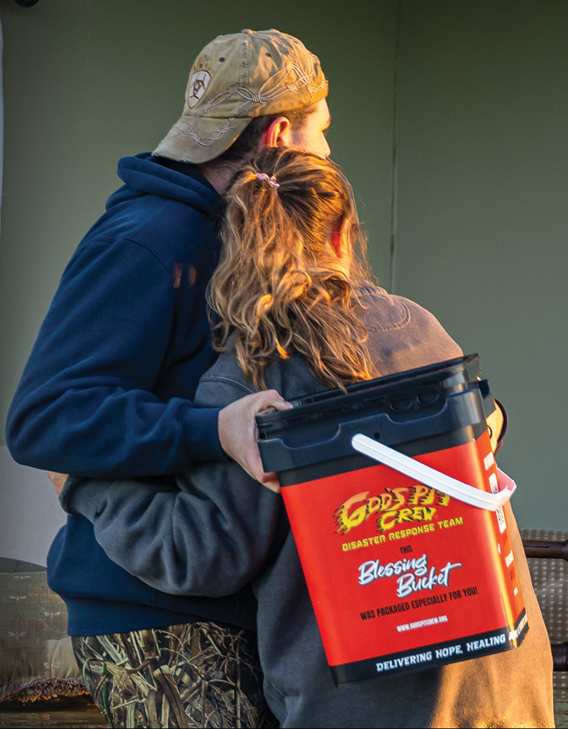 Couple holding a disaster relief bucket.