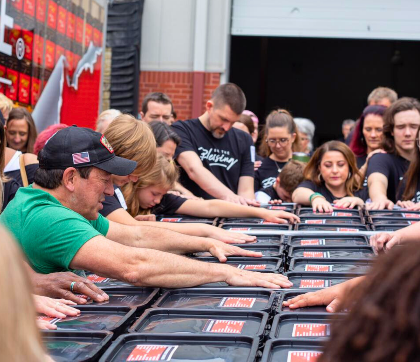 People touching containers in a group event.